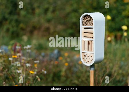Modern Insect Hotel Modern insect hotel on a pole in a garden with shelter for bees ...