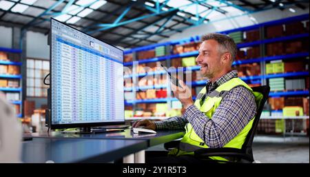 Warehouse Inventory Management On Computer. Staff In Office Stock Photo
