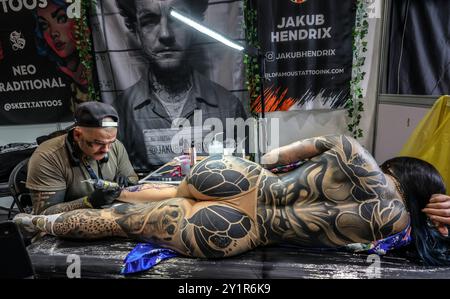 london Excel 08-Sep-2024 The Big London Tattoo Show comes back with fire skills sideshows, and through art look inwards to showcase the incredible skills of 450 of the very best international tattoo artists resident within the UK, Ireland and abroad, creating amazing masterpieces on skin, Credit: Paul Quezada-Neiman/Alamy Live News Stock Photo