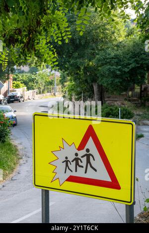 croatian road safety sign warning of the risk of collisoin with children walking across the road Stock Photo