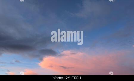Cloudy sunset dramatic skies background, evening colourful sky template, painted clouds wallpaper Stock Photo