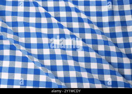 Blue and white checkered gingham fabric as background, closeup Stock Photo
