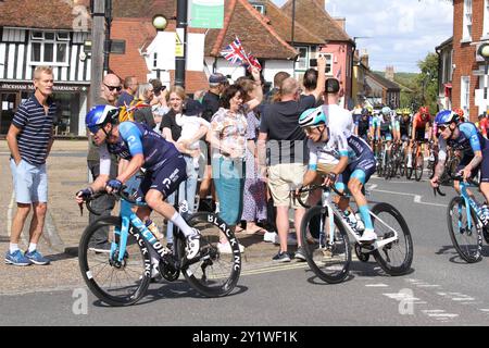 Wickham Market, UK. 8th Sep 2024. The men's cycling event, the Tour of Britain, finishes today with stage 6 in East Suffolk, starting in Lowestoft and finishing in Felixstowe. The riders are passing through Wickham Market. Simon Clarke of team Israel-Premier Tech leads the riders followed by Pello Bilbao of team Bahrain Victorious and Jake Stewart also of team Israel-Premier Tech. Credit: Eastern Views/Alamy Live News Stock Photo