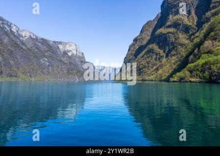 Along the way there are snow-capped mountains, waterfalls and lake reflections. Cruise the World Heritage Sognefjord and enjoy the beautiful scenery. Stock Photo