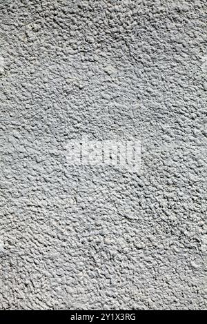 Gray concrete wall, background. The texture of the old wall with plaster and gray whitewash with water-based paint. Unsmooth but flat surface Stock Photo