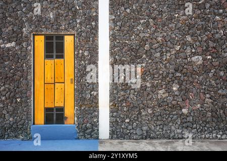 Building wall made of volcanic rocks, architectural background Stock Photo