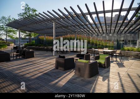 metal construction shelter. L-shaped ribs shading blinds with stripes on promenade in the park Stock Photo