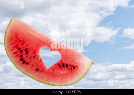 a piece of ripe watermelon against the blue sky Stock Photo