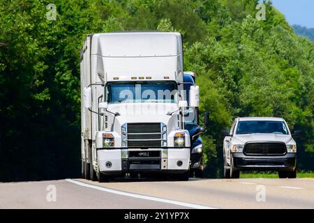 Horizontal shot of two white trucks on a Tennessee interstate Stock Photo