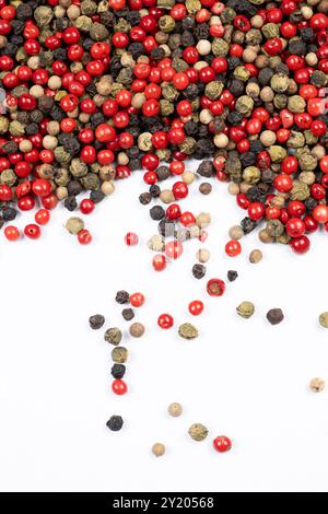 Red, green, white and black peppercorns on a white background top view Stock Photo