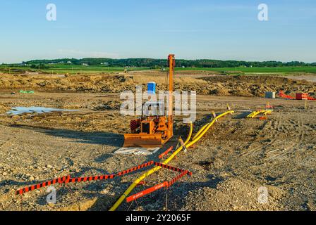 Installing a natural gas feeder line to a new residential subdivision under construction Stock Photo