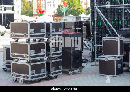 Stage equipment before the concert. Boxes with concert equipment: speakers, lighting, amplifiers, LED panels and cables. Stock Photo