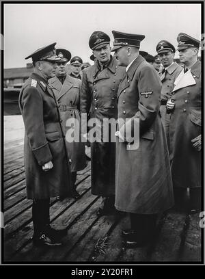 Romanian dictator, Marshal Ion Antonescu (left), converses with Adolf Hitler during an official visit to Germany, as Nazi officials look on. Pictured in the center is Hitler's interpreter, Paul Schmidt. Second from the right is Julius Schaub and at the far right, Joachim von Ribbentrop. The alliance was primarily driven by Antonescu’s desire to regain territories like Bessarabia and Northern Bukovina, which had been lost to the Soviets. The collaboration also led to Romania’s participation in the Holocaust, with Antonescu’s regime playing a significant role in the persecution of Jews. Stock Photo