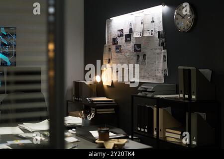 Modern office workspace featuring illuminated bulletin board filled with various documents and photos, indicating active brainstorming and project planning Stock Photo