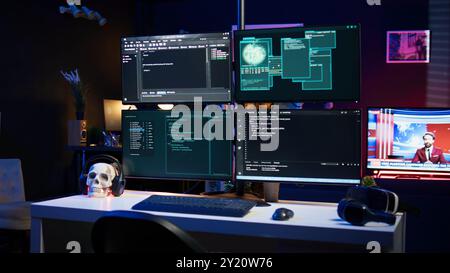 Close up of dangerous hacking lines of code running on computer monitors in criminal den. Programming scripts shown on PC displays in empty hideout used by cybercriminals to steal data Stock Photo