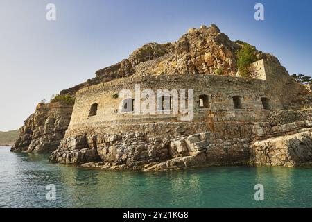 Historic rock fortress on the edge of the sea under a clear blue sky, Venetian sea fortress, Leper Island, Spinalonga, Elounda Bay, Mirabello Bay, Eas Stock Photo