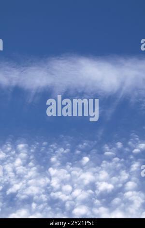 Streaky and puffy Cirrocumulus Clouds against blue sky. Portrait orientation Stock Photo