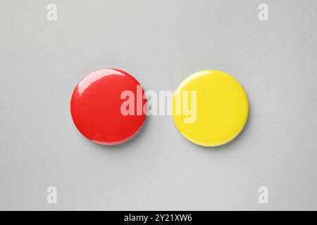 Blank colorful button badges on grey background, top view. Mockup for design Stock Photo