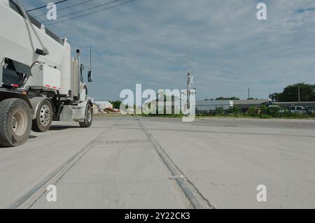 Leading lines of Side view Railroad tracks of a large white cement truck late afternoon with blue sky and white clouds in back.Railroad tracks Stock Photo