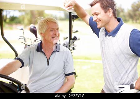 Smile, chat and men in golf cart together for game, outdoor bonding and fitness on weekend morning. Love, senior dad and son in buggy for sports Stock Photo