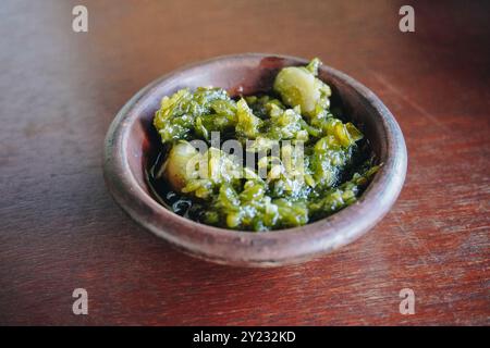 Sambal Ijo or traditional Indonesian spicy green chili sauce made with ingredients onion, green chilies, garlic, and salt. Stock Photo