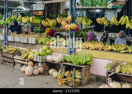 Vibrant street market stall brimming with fresh and colorful fruits neatly displayed in plastic and wooden crates. Stock Photo