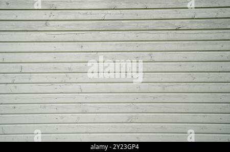Gray wooden wall made of panels as a striped background. Stock Photo