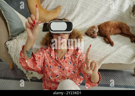 Woman Using VR Glasses To Watch Video Stock Photo