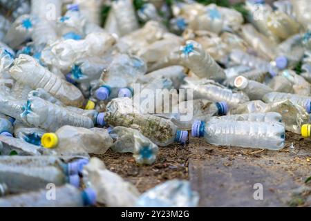 View of many used dirty plastic bottles on the ground. Stock Photo