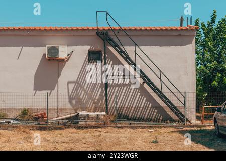Old house in Greece, staircase casting a shadow on the wall. Selective focus Stock Photo