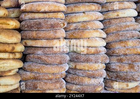 Stack of fresh Moroccan bread at street market stall. Traditional freshly baked bread called khubz, batbout, Mkhamer or harcha in Morocco Stock Photo