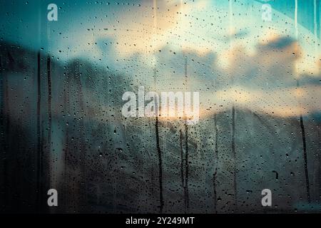 City view through a window on a rainy day.Rain falls on the window glass. Stock Photo