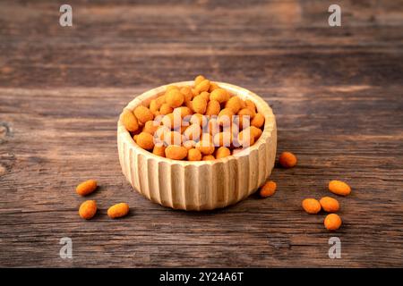 Peanut chips with sauce in bowl on old wooden table stock photo. High quality photo Stock Photo