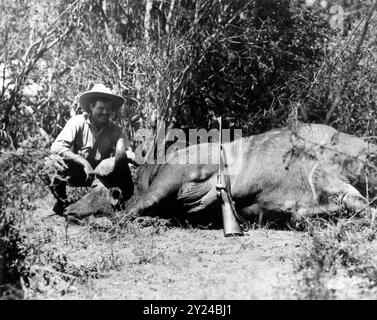 Ernest Hemingway with his 1930 Griffin & Howe .30-06 sporterized Springfield M1903 on safari in Africa after making a kill - unknown photographer Stock Photo