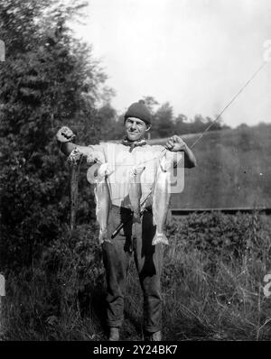 Young Ernest Hemingway, holding fish on a stringer - unknown photographer Stock Photo