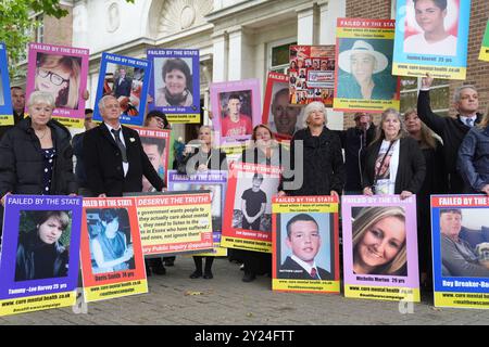 Family members of those lost after receiving treatment for mental health concerns hold up pictures, outside the Lampard Inquiry at Chelmsford Civic Centre before the start of the hearings into the deaths of mental health inpatients in Essex. The inquiry will investigate the deaths of people who were receiving mental health inpatient care in Essex between January 1 2000 and December 31 2023. Picture date: Monday September 9, 2024. Stock Photo