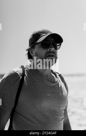 Portrait of bearded man, wearing sunglasses and baseball cap Stock Photo