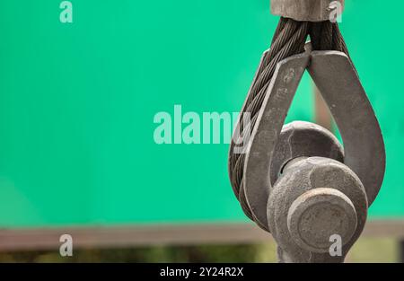 Metal ring and Steel cabling attached to a shackle. Steel wire rope slings with Thimble and safety anchor shackle turnbuckle connection bolt for heavy Stock Photo