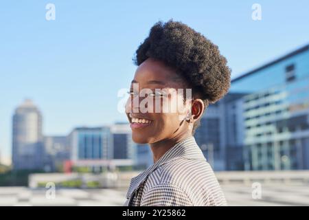 Confident Young Woman Smiling in Urban Cityscape Background Stock Photo