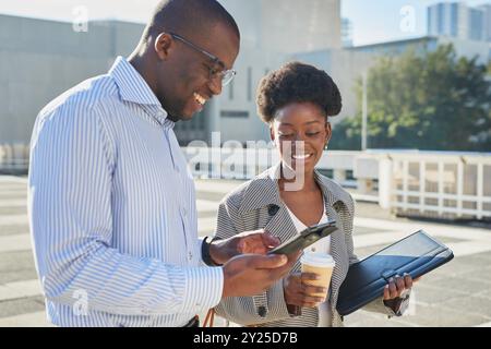 Smiling Business Professionals Discussing Work Outdoors Stock Photo