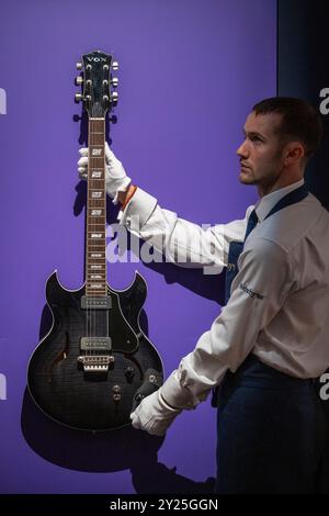 London, UK.  9 September 2024. A technician presents 'A Stage-Played Vox HDC-77 Electric Guitar, Used Extensively Throughout The 3RDEYEGIRL Era, 2013-15' by Prince (Est. £200,000 - 300,000) at a preview of Sotheby’s inaugural Popular Culture online auction.  Lots from the worlds of Rock, Pop and Britpop, and Movies are on offer accompanied by a public exhibition at Sotheby’s New Bond Street galleries from 9 September.  Bids close on 12 September.  Credit: Stephen Chung / Alamy Live News Stock Photo