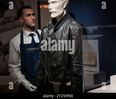 London, UK.  9 September 2024. A technician presents 'A Jean-Paul Gaultier Studded Black Leather Jacket, Stage-Worn By Freddie Mercury At The Dominion Theatre, London, 14th April 1988' by Freddie Mercury (Est. £20,000 - 30,000) at a preview of Sotheby’s inaugural Popular Culture online auction.  Lots from the worlds of Rock, Pop and Britpop, and Movies are on offer accompanied by a public exhibition at Sotheby’s New Bond Street galleries from 9 September.  Bids close on 12 September.  Credit: Stephen Chung / Alamy Live News Stock Photo