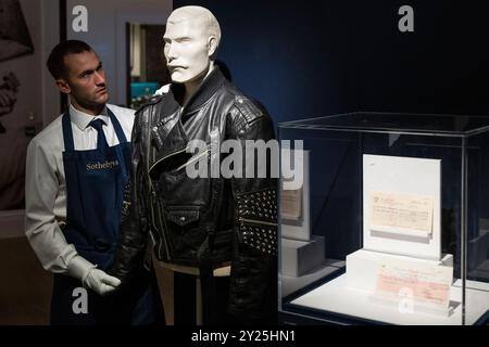 London, UK.  9 September 2024. A technician presents 'A Jean-Paul Gaultier Studded Black Leather Jacket, Stage-Worn By Freddie Mercury At The Dominion Theatre, London, 14th April 1988' by Freddie Mercury (Est. £20,000 - 30,000) at a preview of Sotheby’s inaugural Popular Culture online auction.  Lots from the worlds of Rock, Pop and Britpop, and Movies are on offer accompanied by a public exhibition at Sotheby’s New Bond Street galleries from 9 September.  Bids close on 12 September.  Credit: Stephen Chung / Ģ����ý Live News Stock Photo