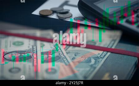 Stock market chart illustrating growth trends, with close-up calculator placed on stack of bills and coins. Financial analysis, investment growth Stock Photo