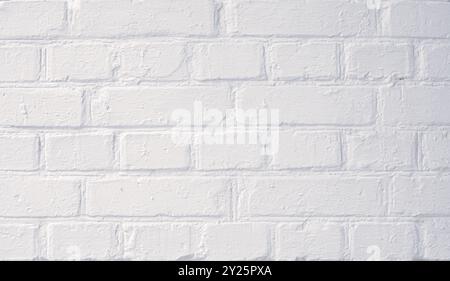 White painted brick wall with smooth texture, suitable for backgrounds or design elements in various settings Stock Photo