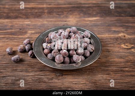 Roasted hazelnuts in shell on old wooden table. High quality photo Stock Photo
