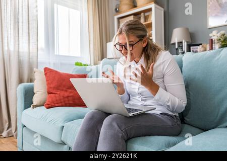 Confident businesswoman executive coach in business casual clothes using laptop computer, having video conference call virtual meeting, professional t Stock Photo