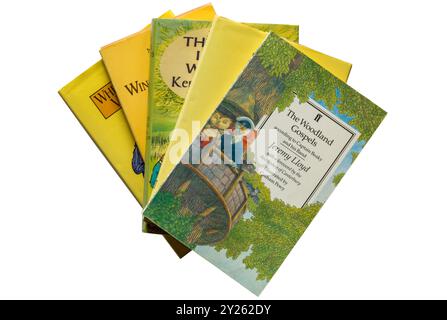 Selection of childrens books with The Woodland Gospels book according to Captain Beaky and his band on top isolated on white background Stock Photo