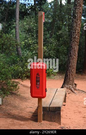 Fire Extinguisher in Mediterranean Forest on 'Sentier des ocres', Ochre Trail of Footpath Roussillon Luberon Regional Park Vaucluse Provence France Stock Photo