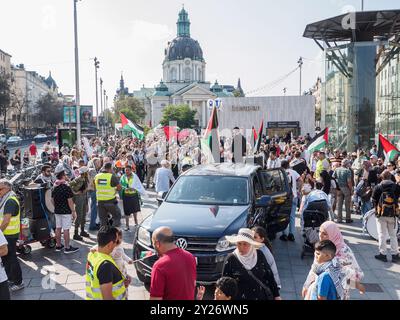 Stockholm, Sweden - September 7 2024: Protestors fill the square outside Odenplan subway station for an anti-Israel march. A car is prominently displa Stock Photo